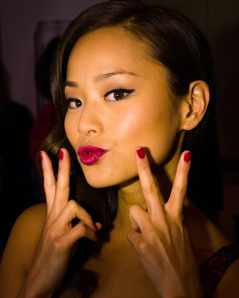 Female model holding her hand to her face with Deborah Lippmann nail polish on